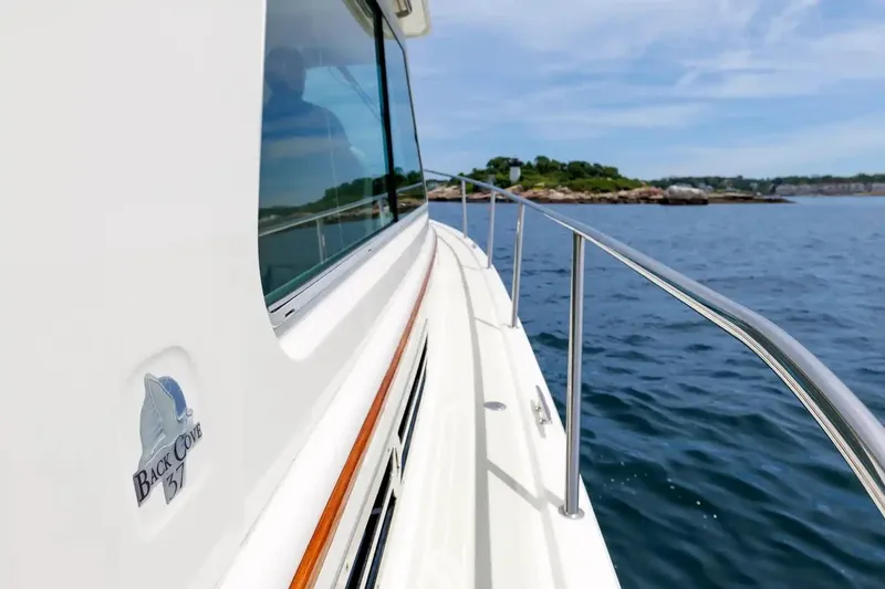 Slide: The Image of 2017 Back Cove Yachts 37 cruising on calm waters near a scenic shoreline. - 22