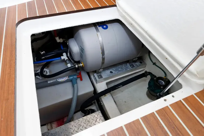 Slide: The Image of Engine compartment of a 2017 Back Cove Yachts 37, showcasing mechanical components and storage. - 55