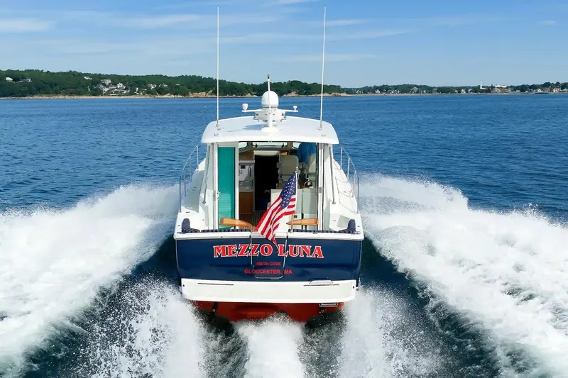 Slide: The Image of 2017 Back Cove Yachts 37 cruising on open water, displaying American flag. - 11