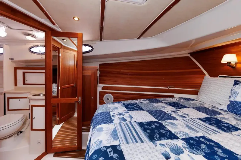 Slide: The Image of Luxurious cabin interior of 2017 Back Cove Yachts 37, featuring wood accents and nautical bedding. - 49