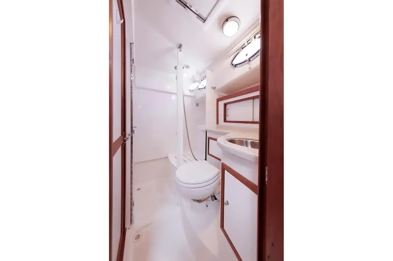 Slide: The Image of 2017 Back Cove Yachts 37 bathroom interior with shower, sink, and toilet. - 52