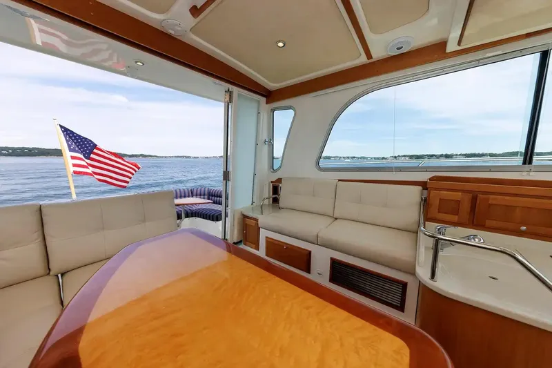 Slide: The Image of Interior of 2017 Back Cove Yachts 37 with American flag, elegant seating, and ocean view. - 31