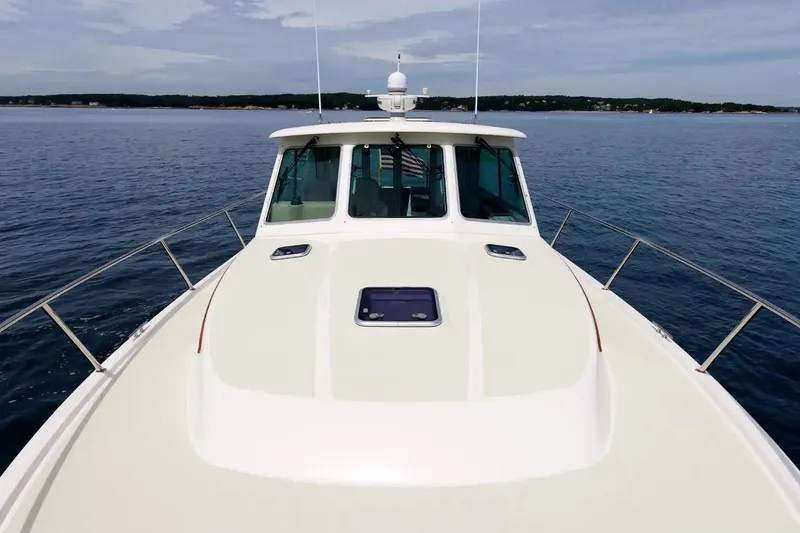 Slide: The Image of 2017 Back Cove Yachts 37 cruising on calm waters, showcasing sleek design and spacious deck. - 19