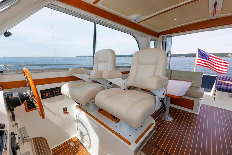 Slide: The Image of Interior of 2017 Back Cove Yachts 37 with helm seats and American flag view. - 30