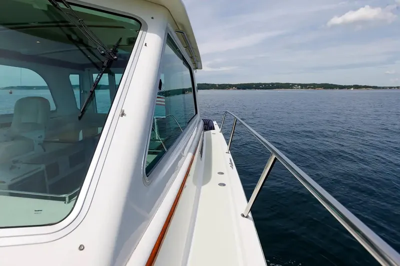Slide: The Image of 2017 Back Cove Yachts 37 on calm waters, showcasing sleek design and spacious deck. - 20