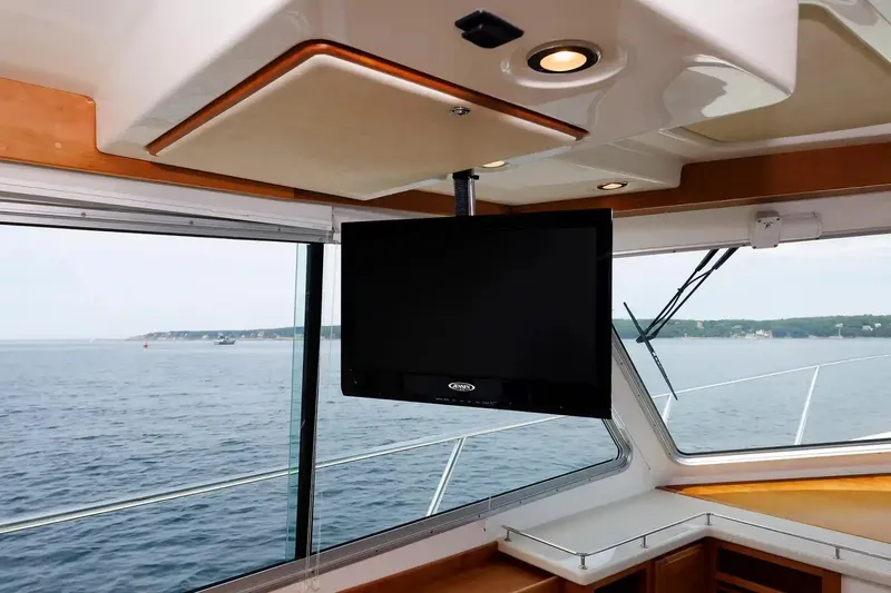 Slide: The Image of Interior view of 2017 Back Cove Yachts 37 with mounted TV and ocean backdrop. - 45