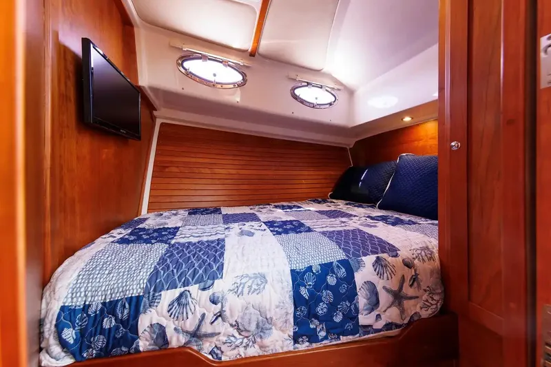 Slide: The Image of Cozy cabin interior of 2017 Back Cove Yachts 37 with nautical-themed bedding. - 50