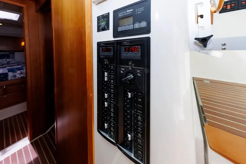 Slide: The Image of Electrical panel inside 2017 Back Cove Yachts 37, featuring Cummins Onan generator controls. - 53