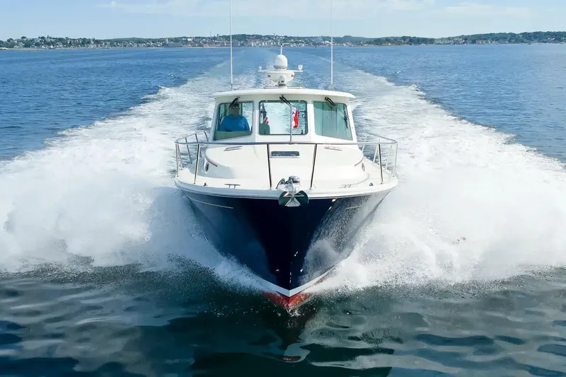 Slide: The Image of 2017 Back Cove Yachts 37 cruising on open water, creating a dynamic wake. - 10