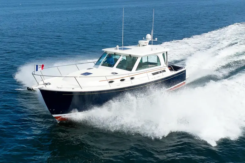 The Image of 2017 Back Cove Yachts 37 cruising on open water, creating a dynamic wake. - 0