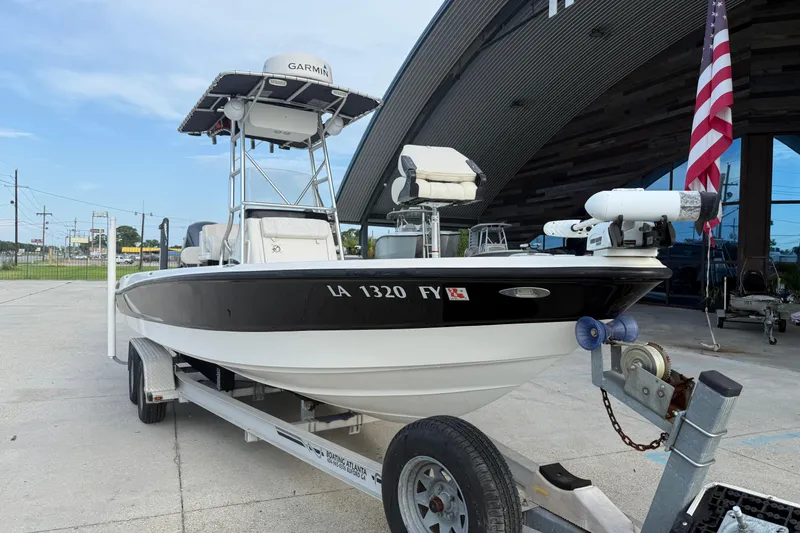 Slide: The Image of 2008 Triton 240 LTS boat on trailer, equipped with Garmin, parked near a building. - 4