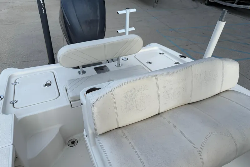 Slide: The Image of 2008 Triton 240 LTS boat interior with white seating and storage compartments. - 17