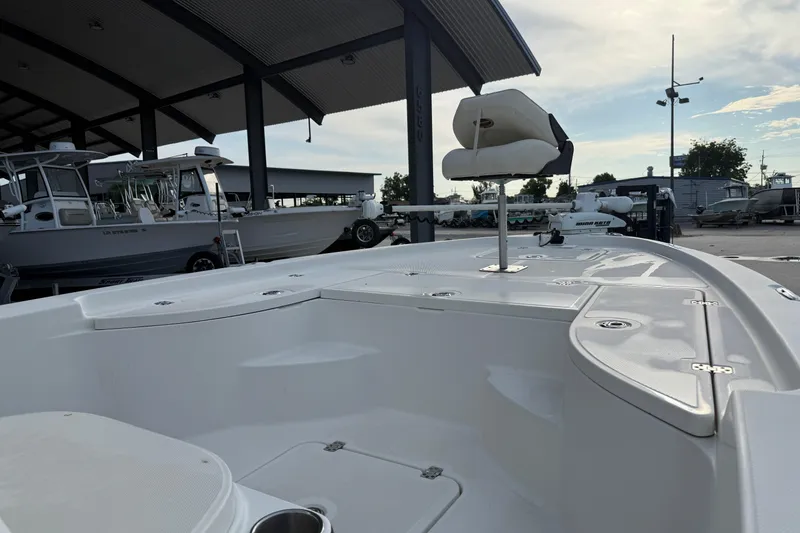 Slide: The Image of 2008 Triton 240 LTS boat interior under covered dock, showcasing seating and deck features. - 14