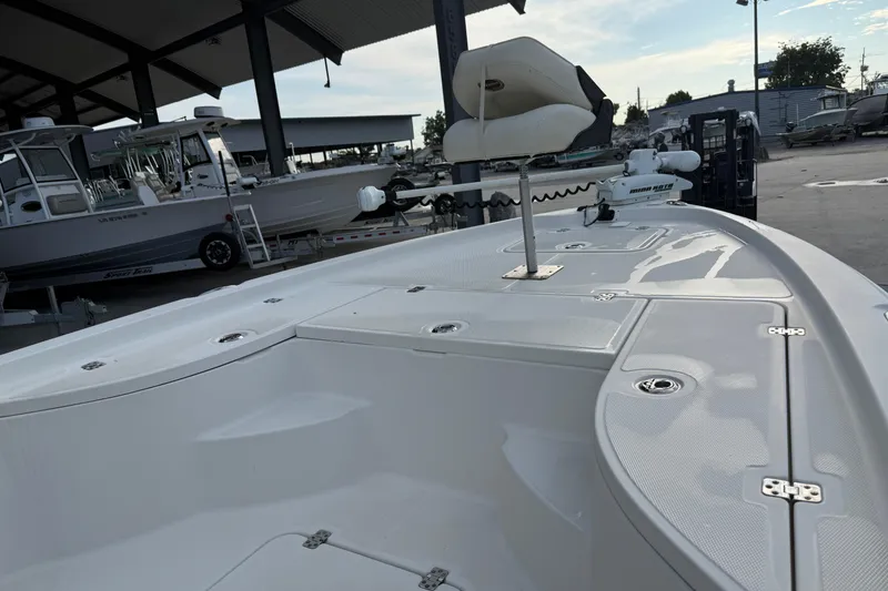 Slide: The Image of 2008 Triton 240 LTS boat deck with seating and equipment in a marina setting. - 15