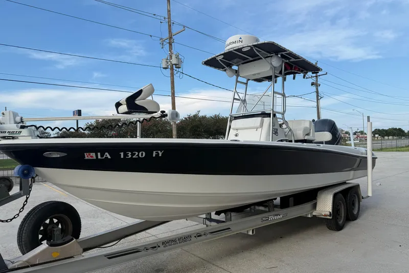 Slide: The Image of 2008 Triton 240 LTS boat on trailer, featuring Garmin equipment, parked outdoors. - 6