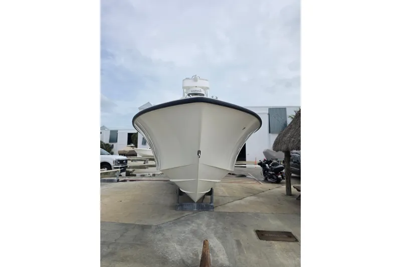 Slide: The Image of 2016 SeaVee 320B boat on trailer, front view, in a marina setting. - 16