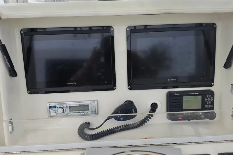 Slide: The Image of 2016 SeaVee 320B dashboard with Garmin displays and communication equipment. - 7