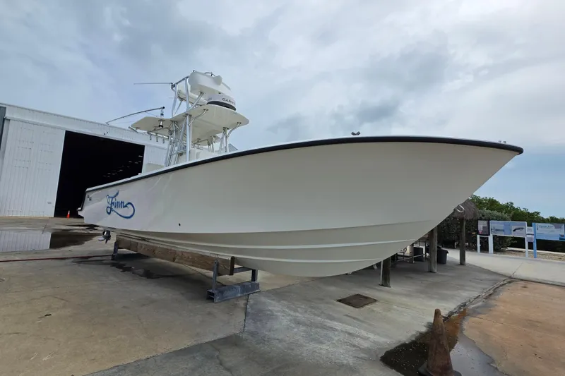 The Image of 2016 SeaVee 320B boat on dry dock, showcasing sleek design and white hull. - 1