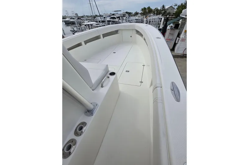 Slide: The Image of 2016 SeaVee 320B boat deck, featuring spacious layout and sleek design at a marina. - 3