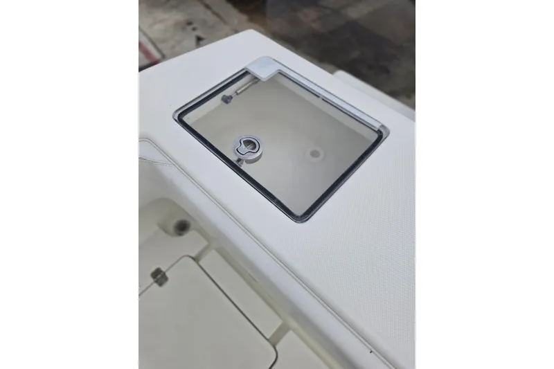 Slide: The Image of 2016 SeaVee 320B boat compartment with a transparent lid and latch. - 11