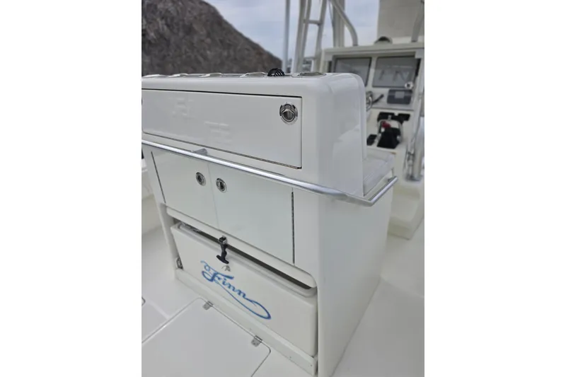 Slide: The Image of 2016 SeaVee 320B boat console with storage compartments and control panel. - 12