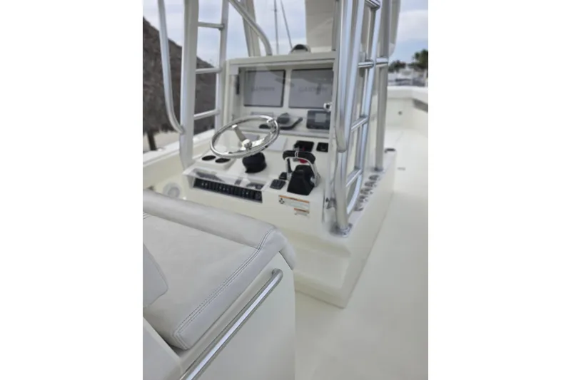 Slide: The Image of 2016 SeaVee 320B boat helm with steering wheel and navigation controls. - 13