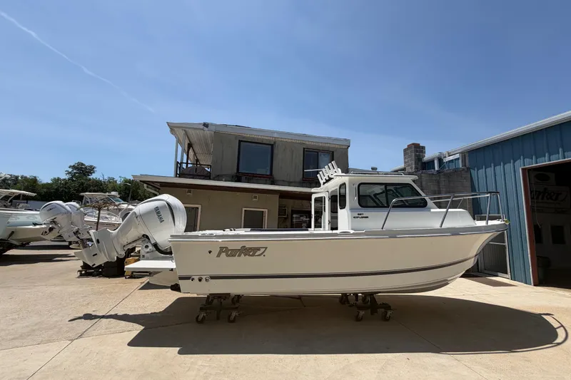 Slide: The Image of 2027 Parker 227 Explorer boat with Yamaha engines in a sunny marina setting. - 3