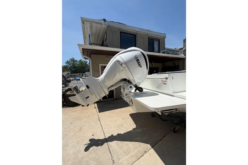 Slide: The Image of 2027 Parker 227 Explorer boat with Yamaha outboard motor, parked outdoors. - 4