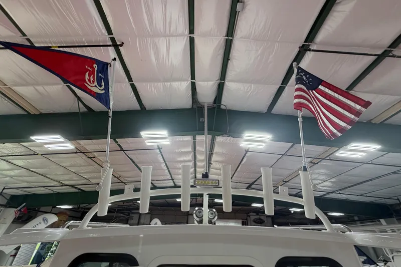 Slide: The Image of Parker 227 Explorer 2027 boat with flags in a well-lit indoor setting. - 17