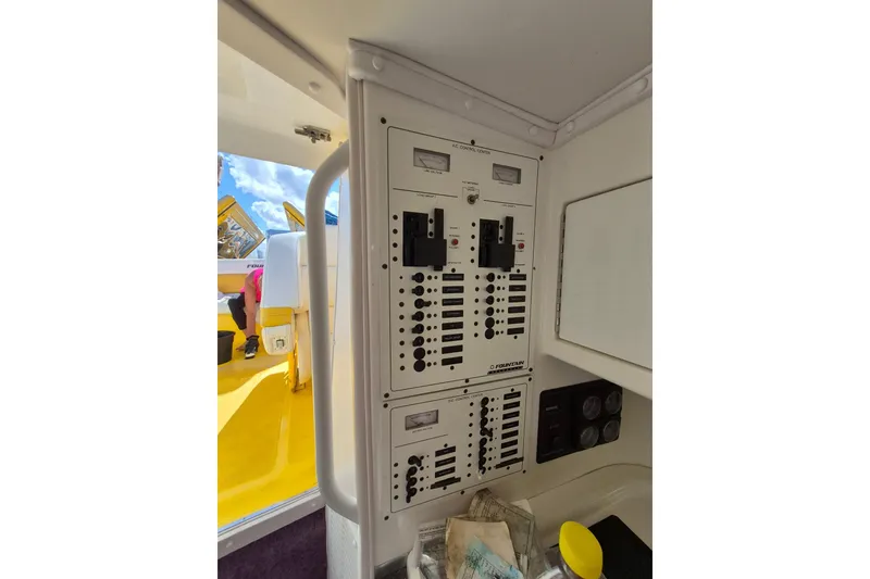 Slide: The Image of Electrical control panel on a 1999 Fountain 47 Lightning boat interior. - 12
