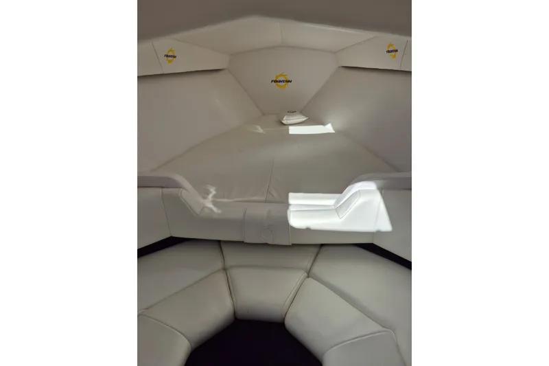 Slide: The Image of Interior cabin of a 1999 Fountain 47 Lightning boat, featuring white leather seating. - 10