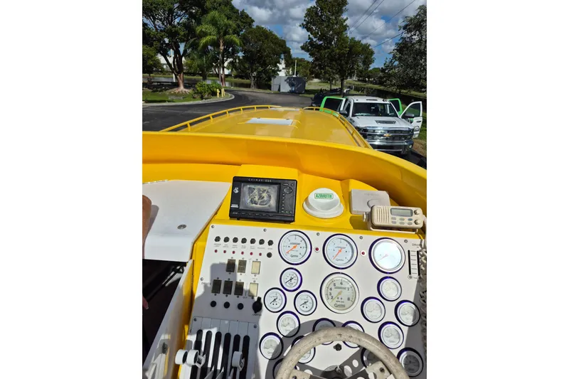 Slide: The Image of Cockpit view of a 1999 Fountain 47 Lightning boat with gauges and controls. - 4