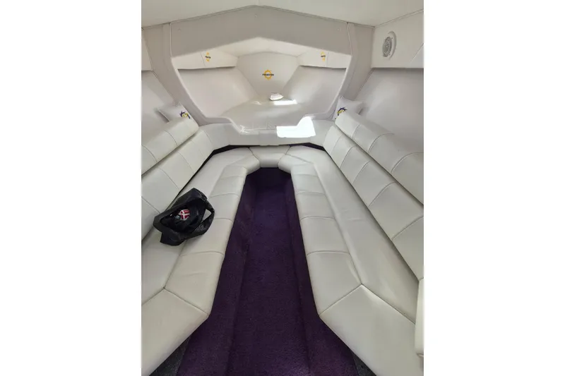 Slide: The Image of Interior of 1999 Fountain 47 Lightning boat with white seating and purple carpet. - 9