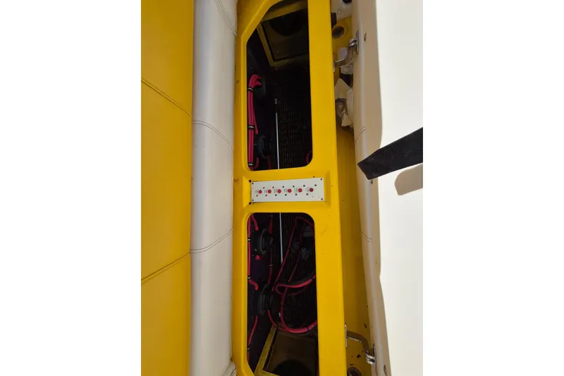 Slide: The Image of Engine compartment of a 1999 Fountain 47 Lightning boat with yellow accents and wiring. - 16