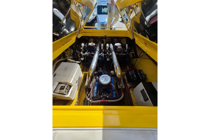 Slide: The Image of Engine compartment of a 1999 Fountain 47 Lightning boat, featuring a powerful engine setup. - 14