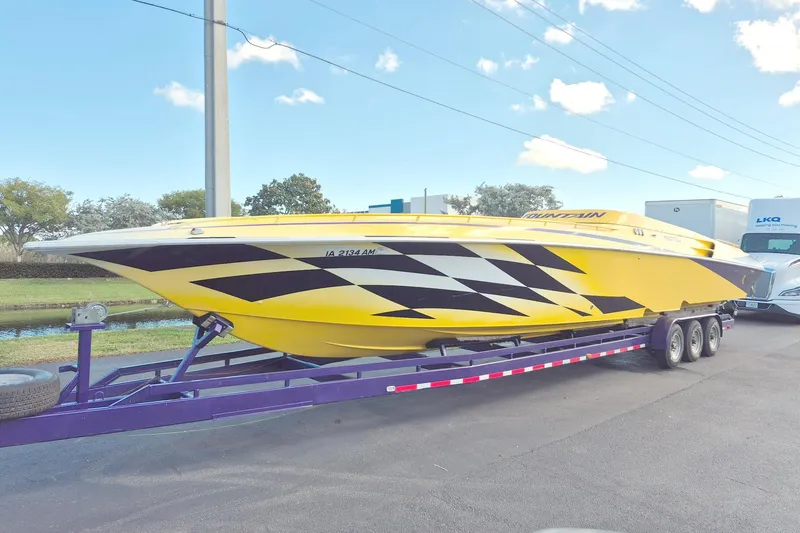 Slide: The Image of Yellow 1999 Fountain 47 Lightning speedboat on trailer, featuring bold black graphics. - 1