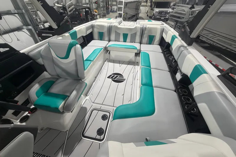 Slide: The Image of 2022 Malibu Wakesetter 23 LSV interior with teal and white seating in a showroom. - 27