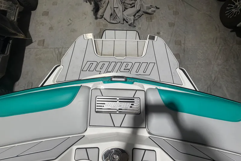 Slide: The Image of 2022 Malibu Wakesetter 23 LSV boat deck with teal and gray accents. - 29