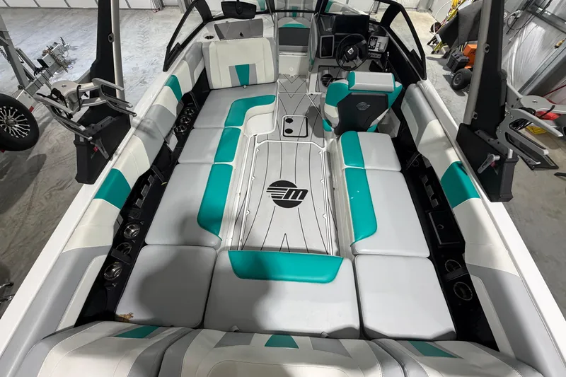 Slide: The Image of 2022 Malibu Wakesetter 23 LSV interior with teal and white seating, modern design. - 9