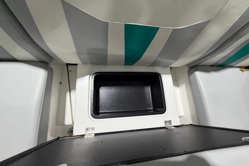 Slide: The Image of 2022 Malibu Wakesetter 23 LSV interior storage compartment with striped upholstery. - 11