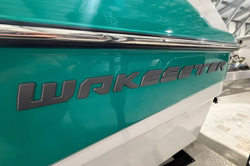 Slide: The Image of 2022 Malibu Wakesetter 23 LSV boat with teal and white exterior detailing. - 2