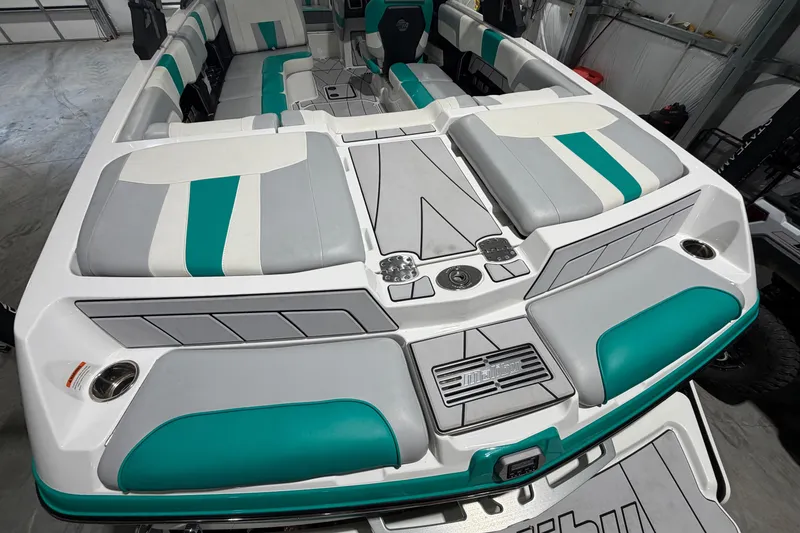 Slide: The Image of 2022 Malibu Wakesetter 23 LSV boat interior with teal and gray seating. - 8