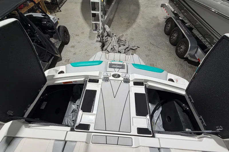Slide: The Image of 2022 Malibu Wakesetter 23 LSV boat interior with open storage compartments in a garage. - 15