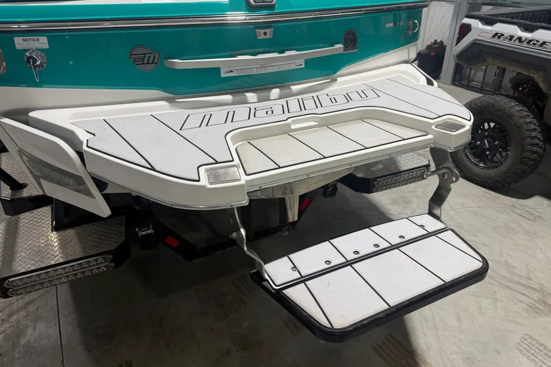 Slide: The Image of 2022 Malibu Wakesetter 23 LSV swim platform with teal and white design. - 6