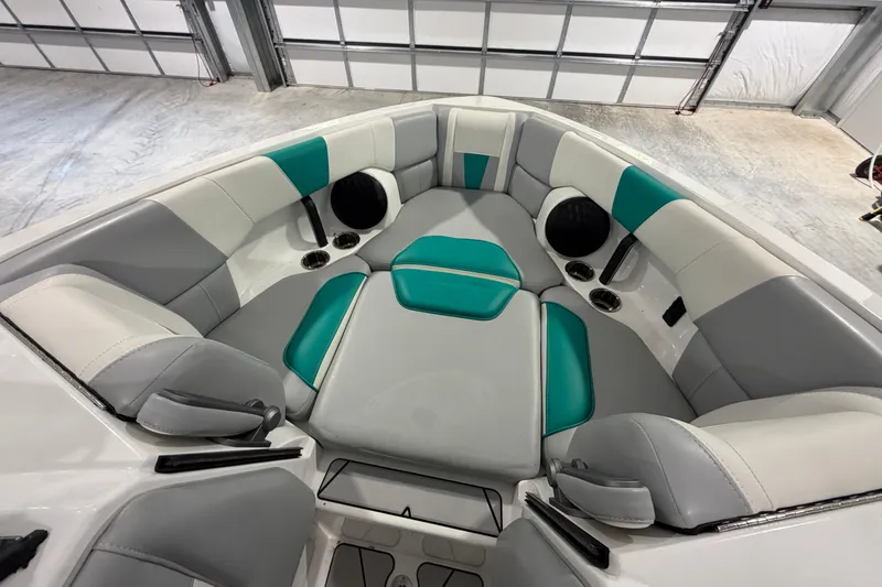 Slide: The Image of Interior of 2022 Malibu Wakesetter 23 LSV boat with teal and gray seating. - 18