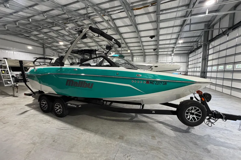 The Image of 2022 Malibu Wakesetter 23 LSV boat in a spacious indoor storage facility. - 0