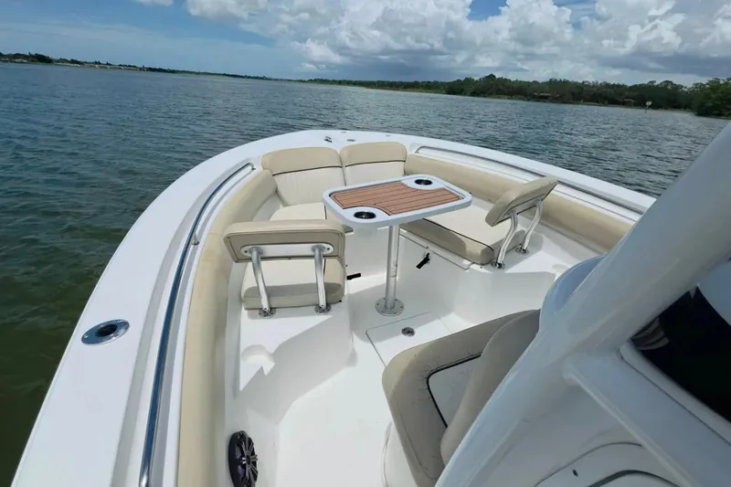 Slide: The Image of 2017 Sea Fox 226 Commander boat interior with seating and table on calm water. - 31