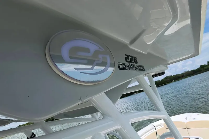 Slide: The Image of 2017 Sea Fox 226 Commander boat detail with logo, on a serene water backdrop. - 44