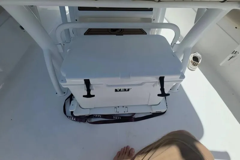 Slide: The Image of YETI cooler on 2017 Sea Fox 226 Commander boat deck, secured with straps. - 13