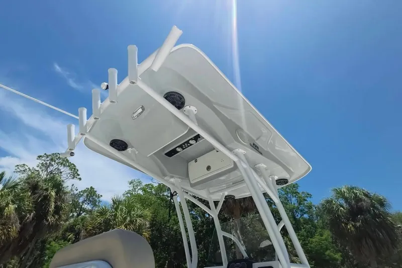 Slide: The Image of 2017 Sea Fox 226 Commander boat T-top under clear blue sky. - 26